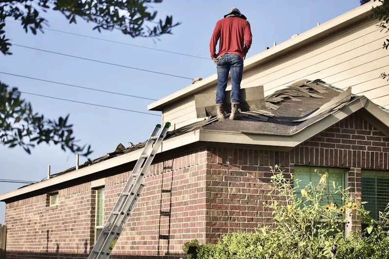 Professional roofer working on a residential roof in Edgartown